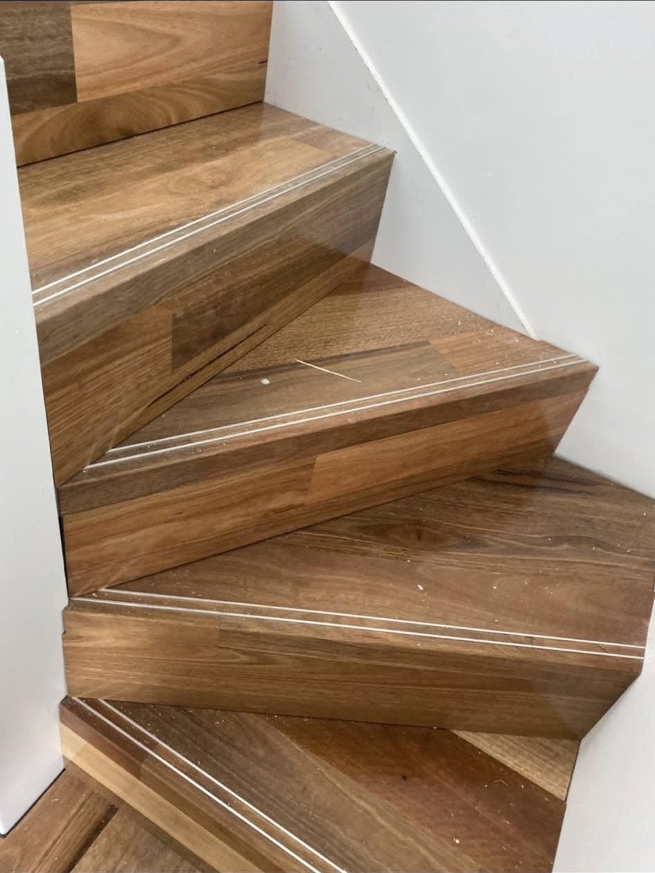 Real Ghane Flooring project: close-up detail of a finished timber staircase with inlay strip